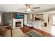 Inviting living room featuring a fireplace, open to the kitchen, and gleaming hardwood floors at 136 Blue Jasmine Ln, Summerville, SC 29483