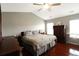 Spacious main bedroom with dark wood furniture and cherry hardwood flooring at 136 Blue Jasmine Ln, Summerville, SC 29483