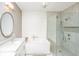 Modern bathroom with tub, shower, double vanity, and large mirror at 136 Fair Sailing Rd, Mount Pleasant, SC 29466