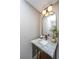 Stylish powder room featuring marble countertop, gold accents, and vanity mirror at 136 Fair Sailing Rd, Mount Pleasant, SC 29466