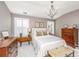Comfortable bedroom with neutral walls, chandelier, and shutters at 136 Fair Sailing Rd, Mount Pleasant, SC 29466