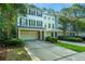Inviting townhome exterior featuring a private garage, landscaping, and driveway at 136 Fair Sailing Rd, Mount Pleasant, SC 29466