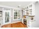 Bright and airy kitchen nook with a wine cooler, custom cabinets, and views to the patio at 136 Fair Sailing Rd, Mount Pleasant, SC 29466