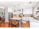 Bright eat-in kitchen boasts stainless appliances, an island, and ample white cabinetry at 136 Fair Sailing Rd, Mount Pleasant, SC 29466