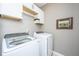 Laundry room with white cabinets and modern washer and dryer units at 136 Fair Sailing Rd, Mount Pleasant, SC 29466