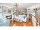 Cozy living room with hardwood floors, fireplace, built-ins, and view to breakfast area at 136 Fair Sailing Rd, Mount Pleasant, SC 29466