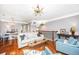 Bright living room featuring hardwood floors, two chairs, and an open staircase and view to breakfast area at 136 Fair Sailing Rd, Mount Pleasant, SC 29466