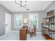 Well-lit home office with two windows, a vintage desk, and an ornate black shelf at 136 Fair Sailing Rd, Mount Pleasant, SC 29466