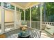 Inviting screened porch features great forest view and comfortable seating at 136 Fair Sailing Rd, Mount Pleasant, SC 29466
