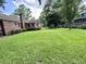 Large backyard with a well-maintained lawn, mature trees and landscaping at 14 Ashland Dr, Charleston, SC 29407