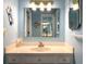 Bright bathroom vanity with white countertop and sink, unique decor and wall mirror at 14 Ashland Dr, Charleston, SC 29407