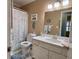 Well-lit bathroom with white fixtures, sea-themed decor, and a shower curtain at 14 Ashland Dr, Charleston, SC 29407