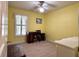 Bedroom with yellow walls, ceiling fan, window with shutters and desk with chair at 14 Ashland Dr, Charleston, SC 29407