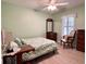 Cozy bedroom with a comfortable bed, window with blinds, ceiling fan, and wood flooring at 14 Ashland Dr, Charleston, SC 29407