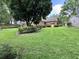 Brick home with a large front yard and landscaping with mature shade trees and green lawn at 14 Ashland Dr, Charleston, SC 29407