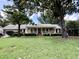 Charming one-story home with inviting front porch and mature trees on a well-manicured lawn at 14 Ashland Dr, Charleston, SC 29407