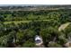 An aerial view features a beautiful silver roof house tucked away in a lush, green forest at 16 Oakwood Ln, Edisto Island, SC 29438