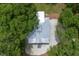 A beautiful overhead shot shows a charming home with its silver roof surrounded by mature trees at 16 Oakwood Ln, Edisto Island, SC 29438