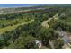 An aerial view shows a home among lush trees, located near marsh and ocean at 16 Oakwood Ln, Edisto Island, SC 29438