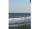 Coastal beach scene with gentle waves rolling onto the sandy shore at 16 Oakwood Ln, Edisto Island, SC 29438