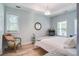 Bedroom featuring a bed, chair, chest of drawers and windows allowing ample natural light in the space at 16 Oakwood Ln, Edisto Island, SC 29438