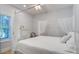 Bright bedroom featuring a canopy bed, complemented by natural light and stylish decor at 16 Oakwood Ln, Edisto Island, SC 29438