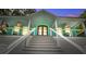 Welcoming front porch showcasing rocking chairs, a ceiling fan, and a beautiful wooden door at 16 Oakwood Ln, Edisto Island, SC 29438