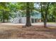 Exterior view of elevated coastal home featuring light blue siding, white trim, and open space underneath at 16 Oakwood Ln, Edisto Island, SC 29438