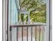 View of a covered outdoor porch area with metal railing and lush green trees in the backyard at 16 Oakwood Ln, Edisto Island, SC 29438