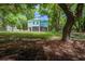 Coastal home featuring a porch and a charming cupola, nestled among mature trees at 16 Oakwood Ln, Edisto Island, SC 29438