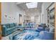 Bright living room with stylish blue sectional, chairs, and view of the kitchen at 16 Oakwood Ln, Edisto Island, SC 29438