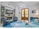 Open-concept living area with cozy seating, fireplace, and built-in shelving at 16 Oakwood Ln, Edisto Island, SC 29438