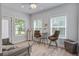 Bright sitting area with table, chairs, loveseat, neutral walls, and plenty of natural light from multiple windows at 16 Oakwood Ln, Edisto Island, SC 29438