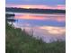 Picturesque sunset reflects beautifully over the water with the pier in the distance at 16 Oakwood Ln, Edisto Island, SC 29438