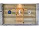 A wooden door with sea-themed decor providing access to the area under the house at 16 Oakwood Ln, Edisto Island, SC 29438
