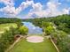 Aerial view of a lakeside community with a stage, fountain, golf course, and tree-lined streets at 165 Village Ponds Dr, Summerville, SC 29483