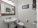 Stylish half bathroom features wood-framed mirror and modern fixtures at 165 Village Ponds Dr, Summerville, SC 29483