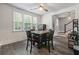 Well-lit dining area featuring hardwood floors, ample natural light, and a comfortable seating arrangement at 165 Village Ponds Dr, Summerville, SC 29483