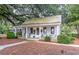 Charming cottage-style building with inviting porch, rocking chairs, and a quaint outdoor seating area at 165 Village Ponds Dr, Summerville, SC 29483
