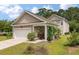 Detached garage with a white door, landscaping, and a connected outdoor sitting area at 165 Village Ponds Dr, Summerville, SC 29483