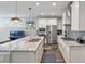 Bright kitchen with stainless steel appliances, an island with pendant lights, and hardwood floors at 165 Village Ponds Dr, Summerville, SC 29483