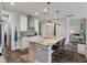 Bright kitchen features island with seating, stainless hood, gray backsplash, and pendant lighting at 165 Village Ponds Dr, Summerville, SC 29483