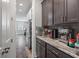 Coffee bar area features marble countertops, dark wood cabinets, and stainless steel coffee machine at 165 Village Ponds Dr, Summerville, SC 29483