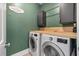 Functional laundry room equipped with modern washer, dryer, and overhead cabinets at 165 Village Ponds Dr, Summerville, SC 29483