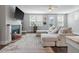 Cozy living room with fireplace, large sectional sofa, and view of the back door at 165 Village Ponds Dr, Summerville, SC 29483