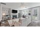 Inviting living room features fireplace, mounted TV, and comfortable sectional sofa at 165 Village Ponds Dr, Summerville, SC 29483