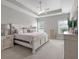 Serene main bedroom features tray ceiling, plush bedding, and natural light at 165 Village Ponds Dr, Summerville, SC 29483