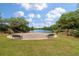 Picturesque park with benches, a lake, and lush trees on a bright day with blue skies at 165 Village Ponds Dr, Summerville, SC 29483