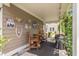 Outdoor patio with vintage signage, rustic wooden chairs, grill, and views of the backyard at 165 Village Ponds Dr, Summerville, SC 29483