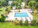 Overhead view of a large community pool area including cabanas, lounge chairs, palm trees, and manicured lawns at 165 Village Ponds Dr, Summerville, SC 29483